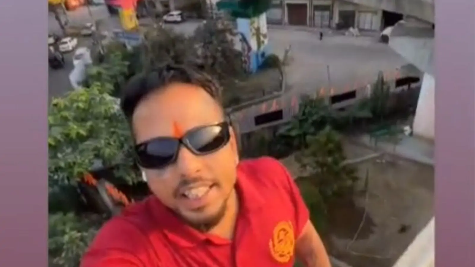 A young man in Jalandhar is making dangerous moves, climbing high bridges and tanks to film his video.
